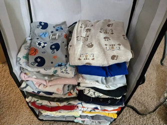 An organized plie of folded baby clothes