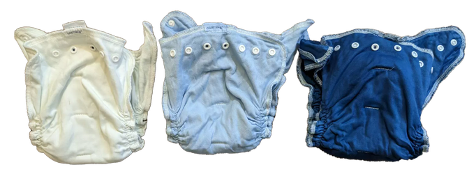 A white diaper, a baby blue diaper, and a blue diaper