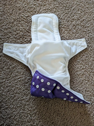 A pocket diaper with the insert sticking out