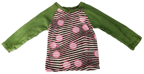 A shirt with black and white stripes and pink circles and green Relan sleeves