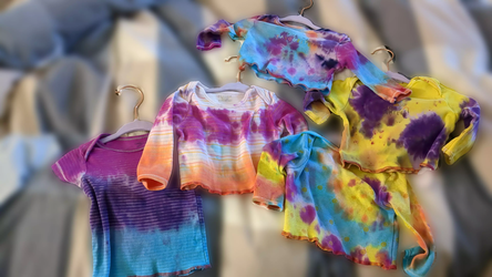 all the tie-dyed shirts layed flat for display