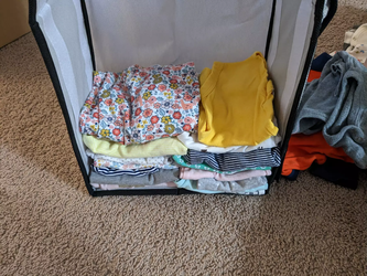 A stack of all the folded newborn onesies